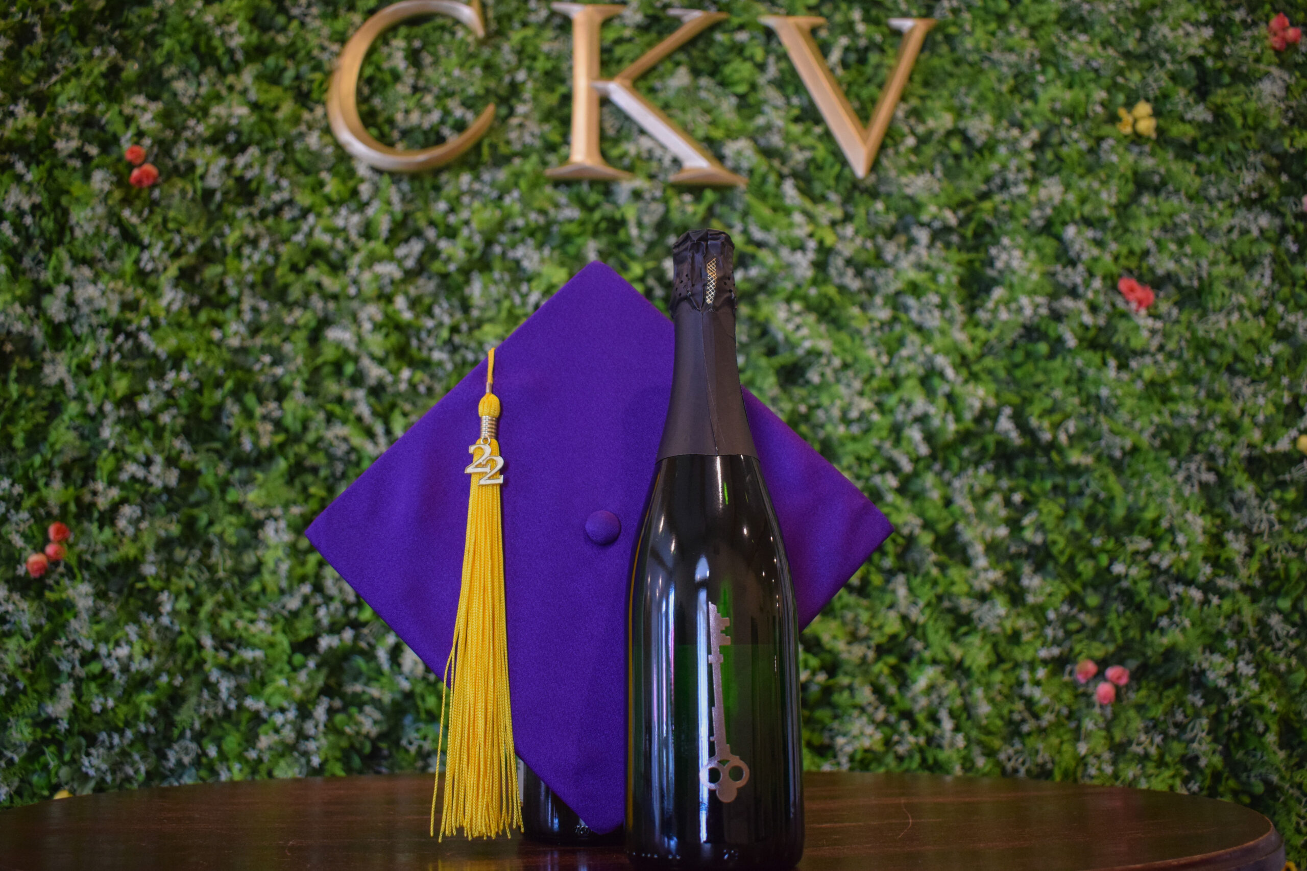 Bottle of wine with purple graduation cap